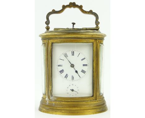 An oval brass cased repeat carriage clock with alarm,
height 5.75".