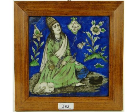 A framed Persian 17th century tile, 
height 10.5" overall.