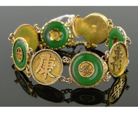 A Chinese 18ct gold and jade 8 panel bracelet,
with Chinese character panels, 21.5g.