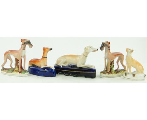 Staffordshire greyhound inkwell, 
length 7.75", similar smaller figure and a pair of greyhounds and another, (5).