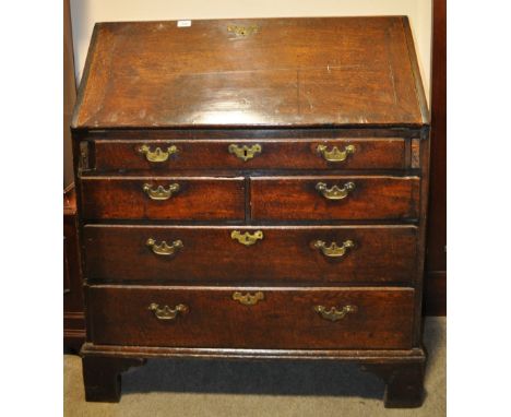 An 18th century oak bureau,
the fall front revealing a drawer fitted interior with 5 drawers under on bracket feet, width 3',