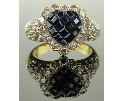 18ct gold heart shaped sapphire and diamond cluster ring,
the heart shaped setting having a calibre cut sapphire panel in 14 