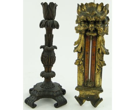 A carved wood candlestick, 11.5"
and an ornate carved giltwood thermometer, (2).
