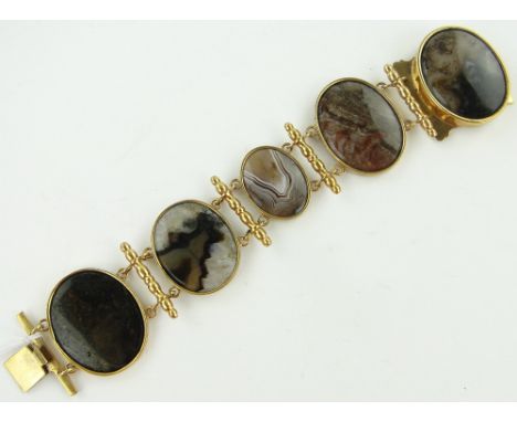 A Victorian polished agate and pinchbeck 5 panel bracelet,
largest panel height 35mm.