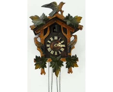 A decorative carved Black Forest cuckoo clock.
