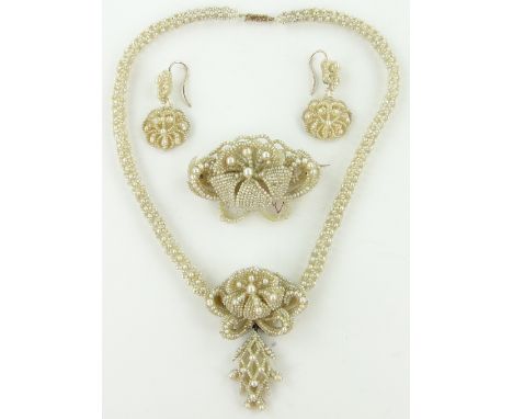 A suite of Victorian seed pearl jewellery,
comprising; an ornate necklace with pendant below, a brooch and a pair of matching