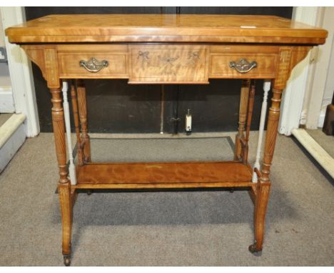 An Edwardian satinwood foldover card table,
of rectangular form having inlaid and painted decoration with 2 short drawers, wi