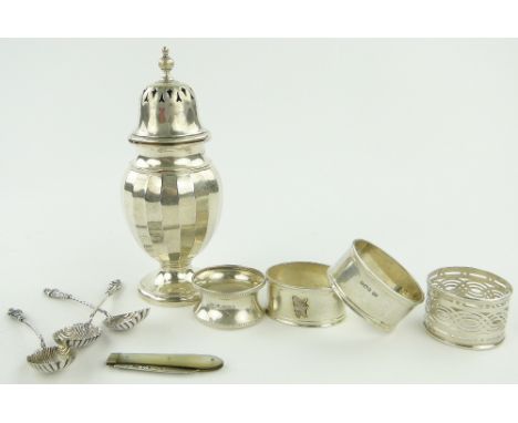A group of silver items,
comprising; sugar caster, 4 napkin rings, 3 Apostle teaspoons and a mother of pearl and silver fruit
