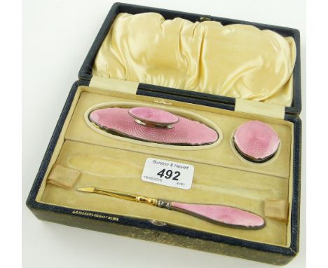 A 3-piece silver and pink enamel manicure set,
makers marks A C, Birmingham 1931, original leather case.