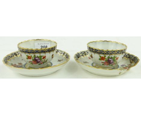 A pair of early porcelain tea bowls and saucers
with painted floral and insect designs, and central windmills finished in gol