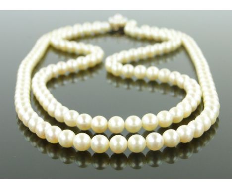 A double string of pearls,
with 9ct pearl-set clasp.