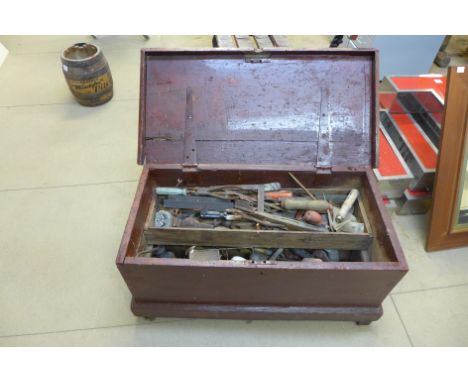 A stained pine tool chest with tools