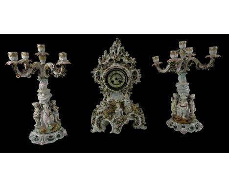 A late 19th century Continental porcelain floral encrusted clock garniture, the garniture formed as a pair of five branch can