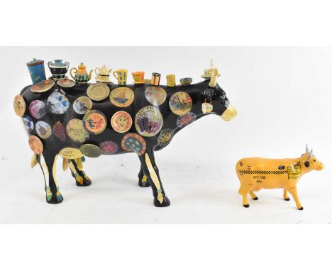 A large Cow Parade Holdings Corporation cow, year 2002, decorated with cups and saucers, height 26cm, length approx 40cm, and