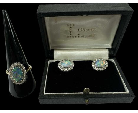 An 18ct yellow gold opal and diamond set ring, the central opal surrounded by twenty small diamonds, size Q/R, with pair of m