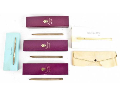 A group of five ballpoint pens; three silver examples by Asprey in their pouches and boxes, a Tiffany &amp; Co example in pou