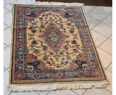 A Persian red and cream ground carpet with floral decoration, 180 x 122cm.