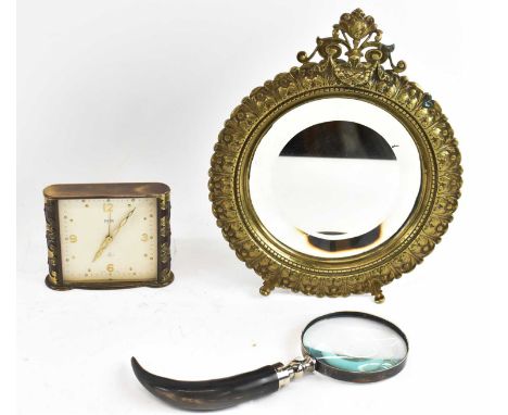 A 19th century gilt metal framed circular easel back mirror, diameter 25cm, a Swiza Mignon red enamelled and brass bound mant