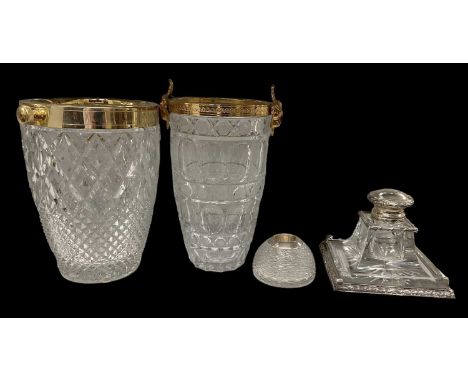 A hallmarked silver mounted cut glass inkwell, a white metal mounted indistinctly marked inkwell with hinged lid, and two gil