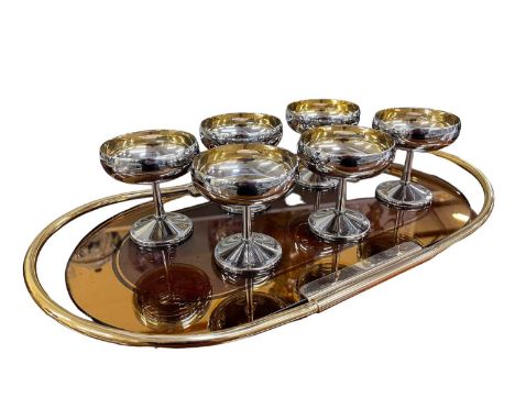An Art Deco style peach glass oval twin handled tray, diameter 53cm, and a set of six silver plated champagne glasses, height