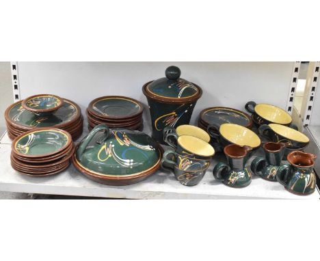 A green glazed stoneware dinner service, indistinctly marked 'AP' to base, comprising five teacups, six larger teacups, three