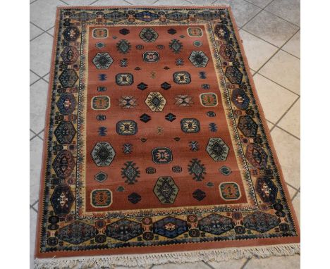 A Persian red ground carpet with geometric border, 181 x 119.5cm.