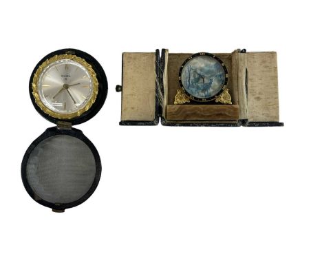 A cased Art Deco style travelling clock, the dial decorated with deer in front of a lake, and a Swiza cased travelling clock 