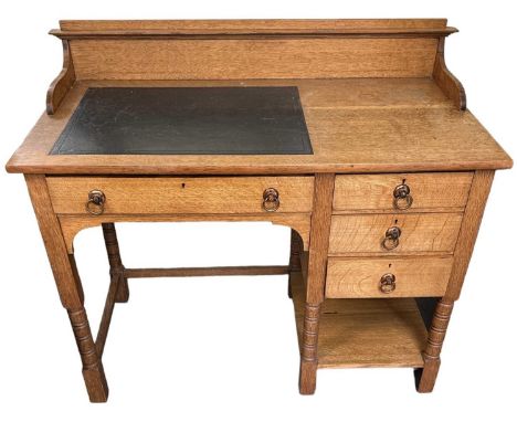 IN THE STYLE OF SHAPLAND &amp; PETTER; an early 20th century light oak Arts and Crafts kneehole desk, with single drawer and 