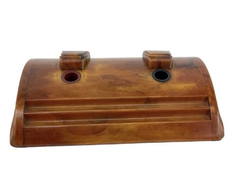 A 1930s Art Deco Bakelite amber coloured inkwell, with sliding covers, width 28.5cm.