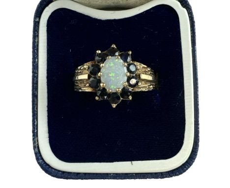A 9ct yellow gold opal and garnet set ring, size O, approx 3g.