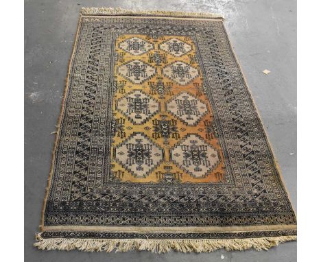 A brown ground Asian style carpet with geometric design, 220 x 125cm.