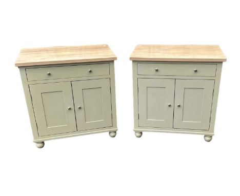 NEPTUNE; a pair of sage green painted side cabinets with light oak tops, single drawer and pair of cupboard doors, width 83cm