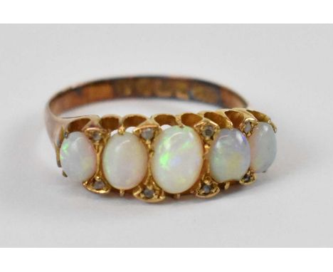 An 18ct yellow gold ring set with five opals, size O, approx 4g.