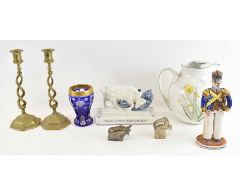 A Delft porcelain Van der Moolen figure, a Portuguese daffodil decorated jug, pair of brass barley twist candlesticks, Bohemi