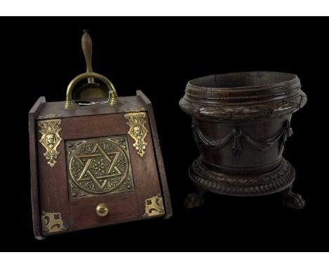 An early 20th century brass bound coal scuttle with shovel and a carved wooden planter on claw feet, diameter 30cm, height 32