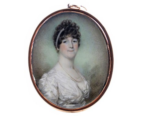 λ Charles Jagger (1770-1827)  Portrait miniature of a lady, head and shoulders, with pearls in her hair  Signed  Oval, gold f