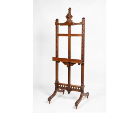 Walnut salon easel with pierced and carved leaf decoration and adjustable shelf 198cm (h), 68cm (w), 63cm (d)