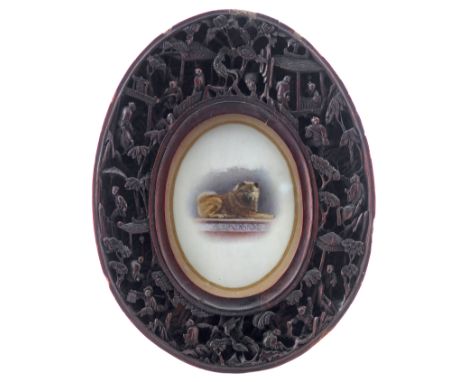 λ Chinese School c. 1900  Portrait miniature of a dog  Oval in an elaborately carved hardwood frame  80 x 60mm  General condi