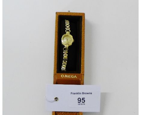 A vintage 9ct gold ladies Omega cocktail watch, the dial with hour batons and inscribed 'Omega', with a conforming winding cr