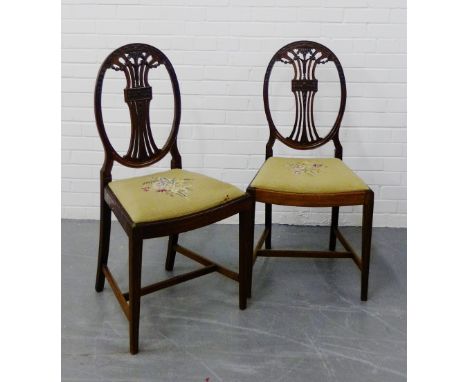 A pair of Sheraton style mahogany side chairs, the oval backs with tapestry slip in seats and tapering supports, 100 x 48cm, 