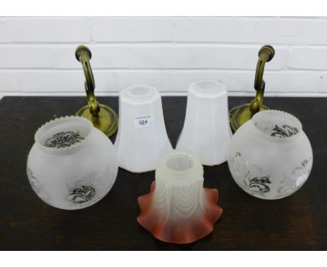 A mixed lot to include a pair of brass metal wall lights, two white opaque glass shades, two etched glass domed shades and an