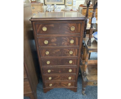 A narrow mahogany chest of seven drawers, with brass ring handles, on bracket feet, 46cm