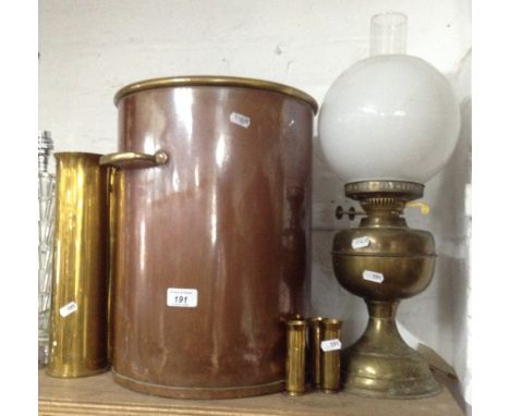 A copper bin with brass handles, shell cases and an oil lamp.