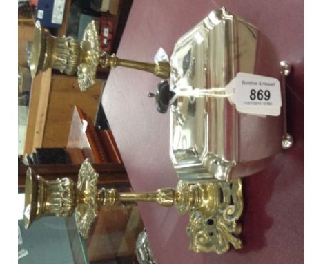 A silver plated sarcophagus tea caddy on bun feet by Mappin & Webb, and a pair of pierced brass candlesticks.