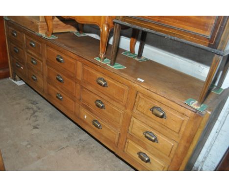 A Vintage low oak 15-drawer haberdashery cabinet, length 207cm, height 71cm, depth 39cm.