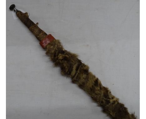 An African lion hunting sword in animal skin bound scabbard.