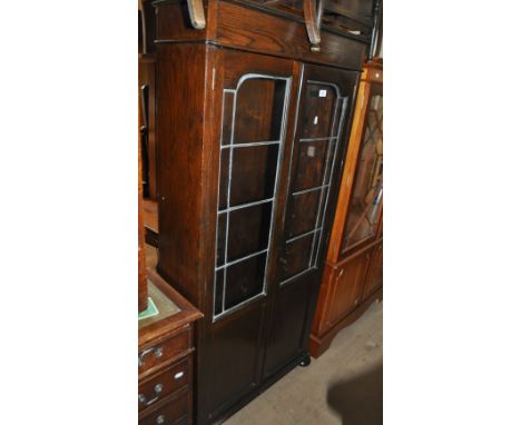 A 1920s oak bookcase with 2 lead light glazed doors, width 73cm.
