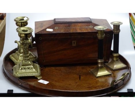 An Edwardian oval mahogany tea tray, 19th century mahogany tea caddy and 2 pairs of brass candlesticks.