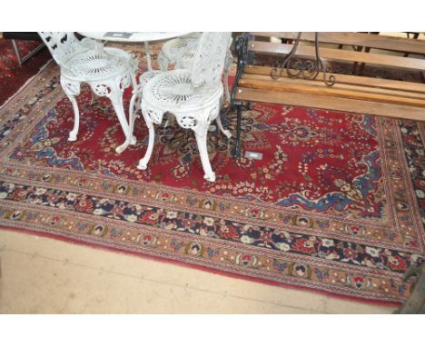 A red and blue ground Persian design carpet with symmetrical pattern and border, 290 x 200cm.