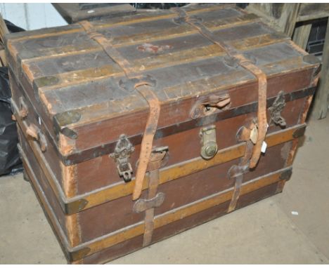 A 19th century slat bound travelling trunk with leather straps, length 87cm.